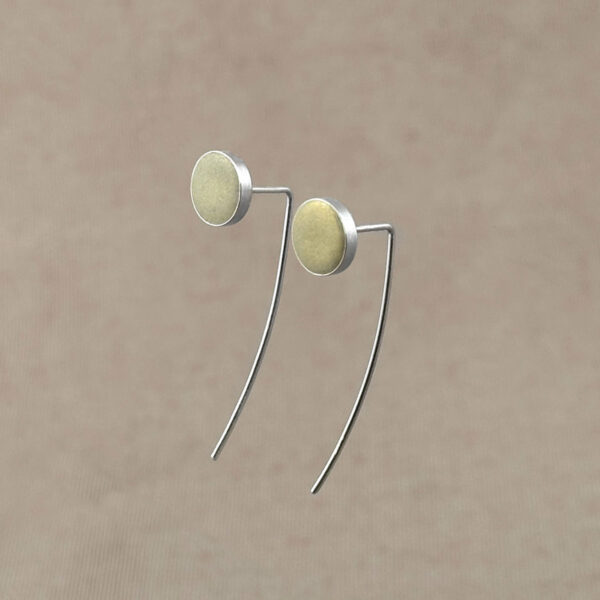 Sterling silver drop earrings with round champagne gold clay discs, floating against a warm taupe background.