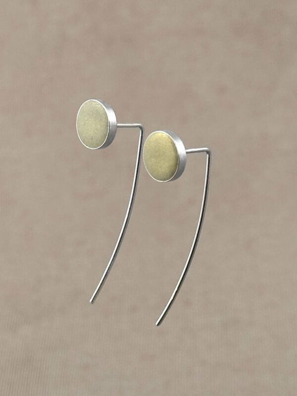 Sterling silver drop earrings with round champagne gold clay discs, floating against a warm taupe background.