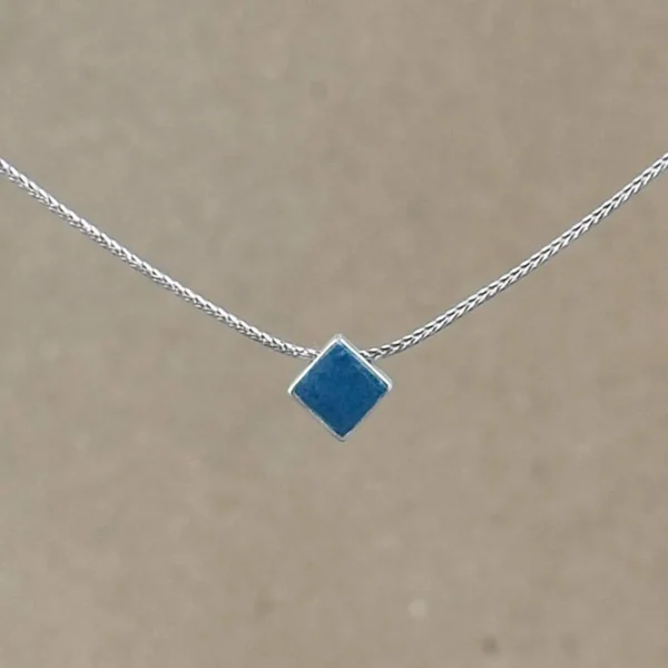 Teal Point necklace — small diamond-shaped teal clay pendant in a sterling silver frame on a fine foxtail chain.
