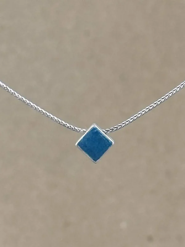 Teal Point necklace — small diamond-shaped teal clay pendant in a sterling silver frame on a fine foxtail chain.