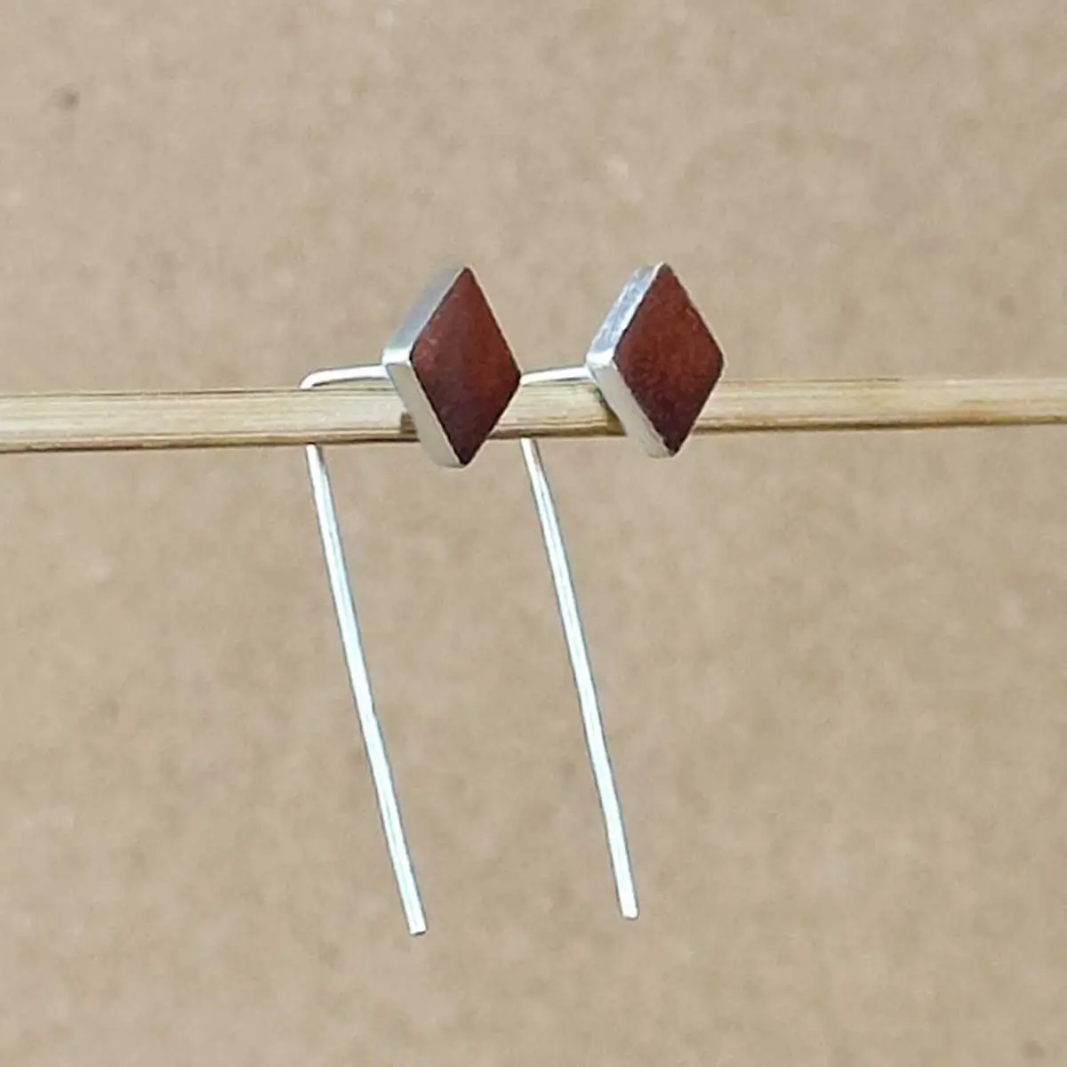 E-CD-copper-diamond-earrings-detail Close-up of shimmering copper clay diamond stud with thin sterling silver dangle wire