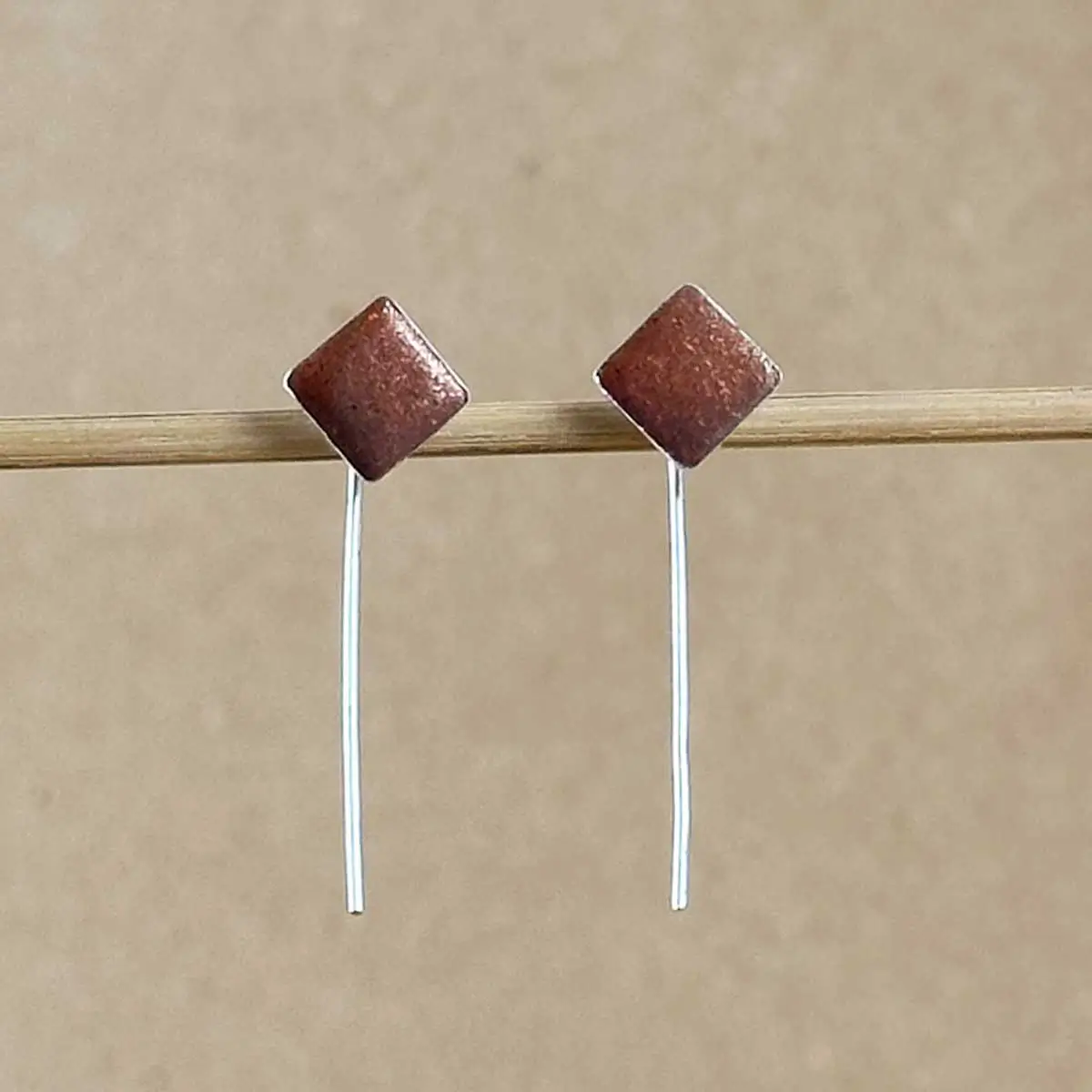 Sterling silver and copper-toned hand-tinted clay diamond earrings with dangle wire detail
