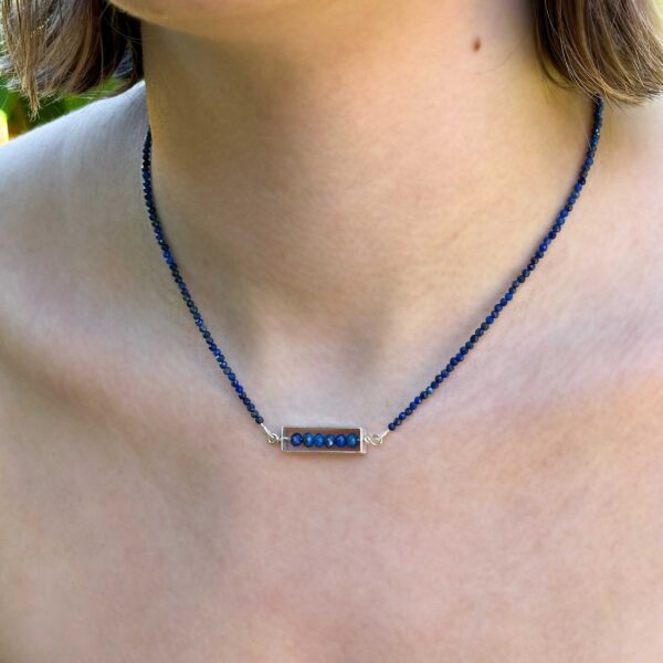 Lapis Frame Necklace worn at the collarbone, showing the pendant's fit and scale on the body.