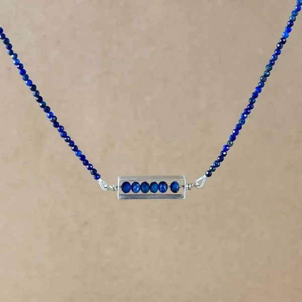 Brushed sterling silver frame pendant strung with faceted lapis lazuli beads on a lapis lazuli beaded chain.